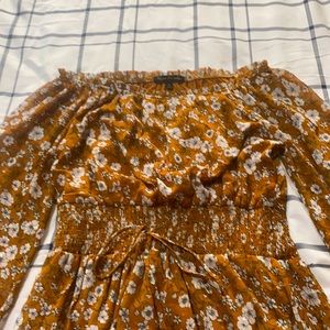 A  brown color  dress with white flowers